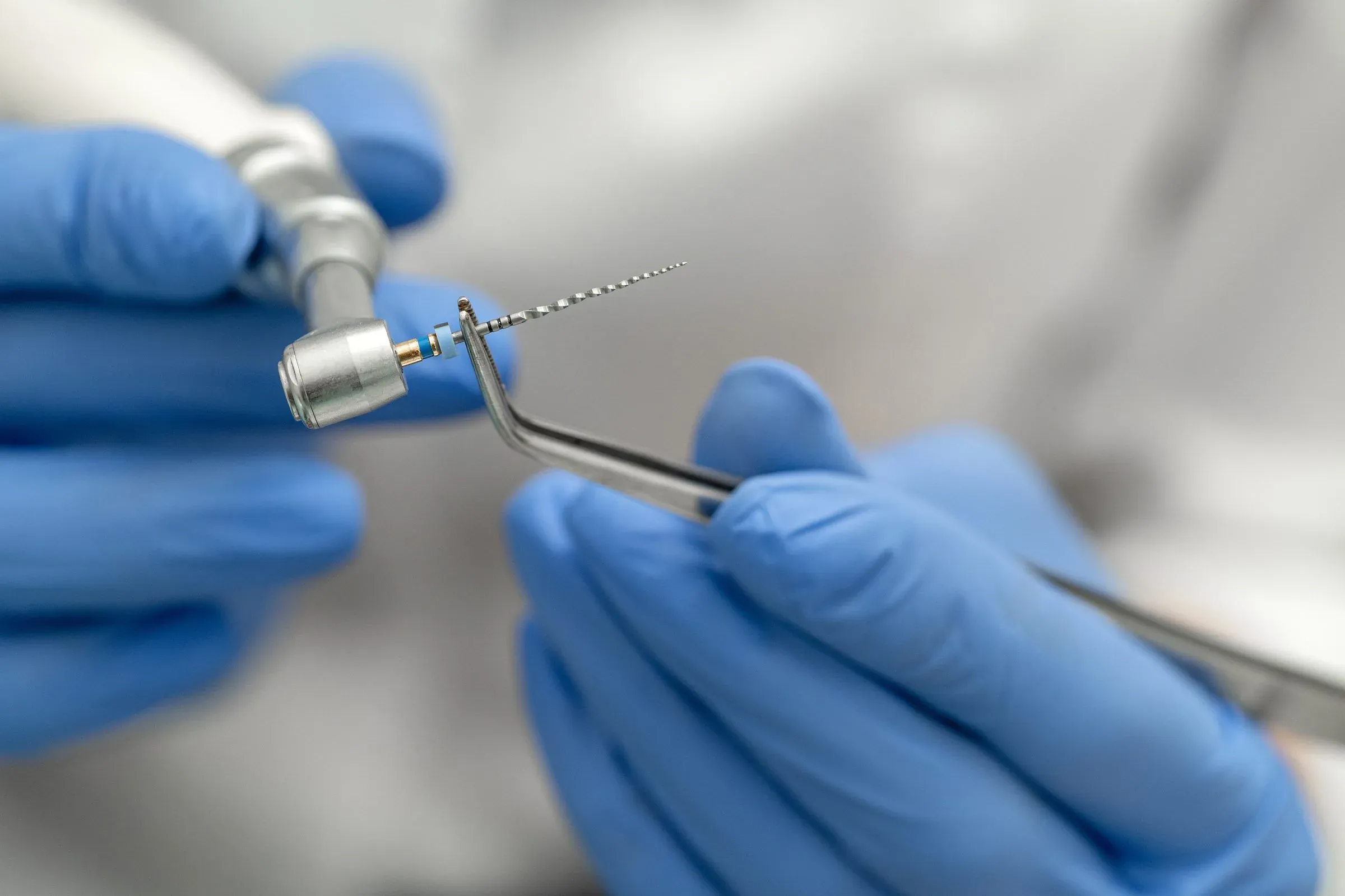 Gloved hands holding a precision medical instrument.