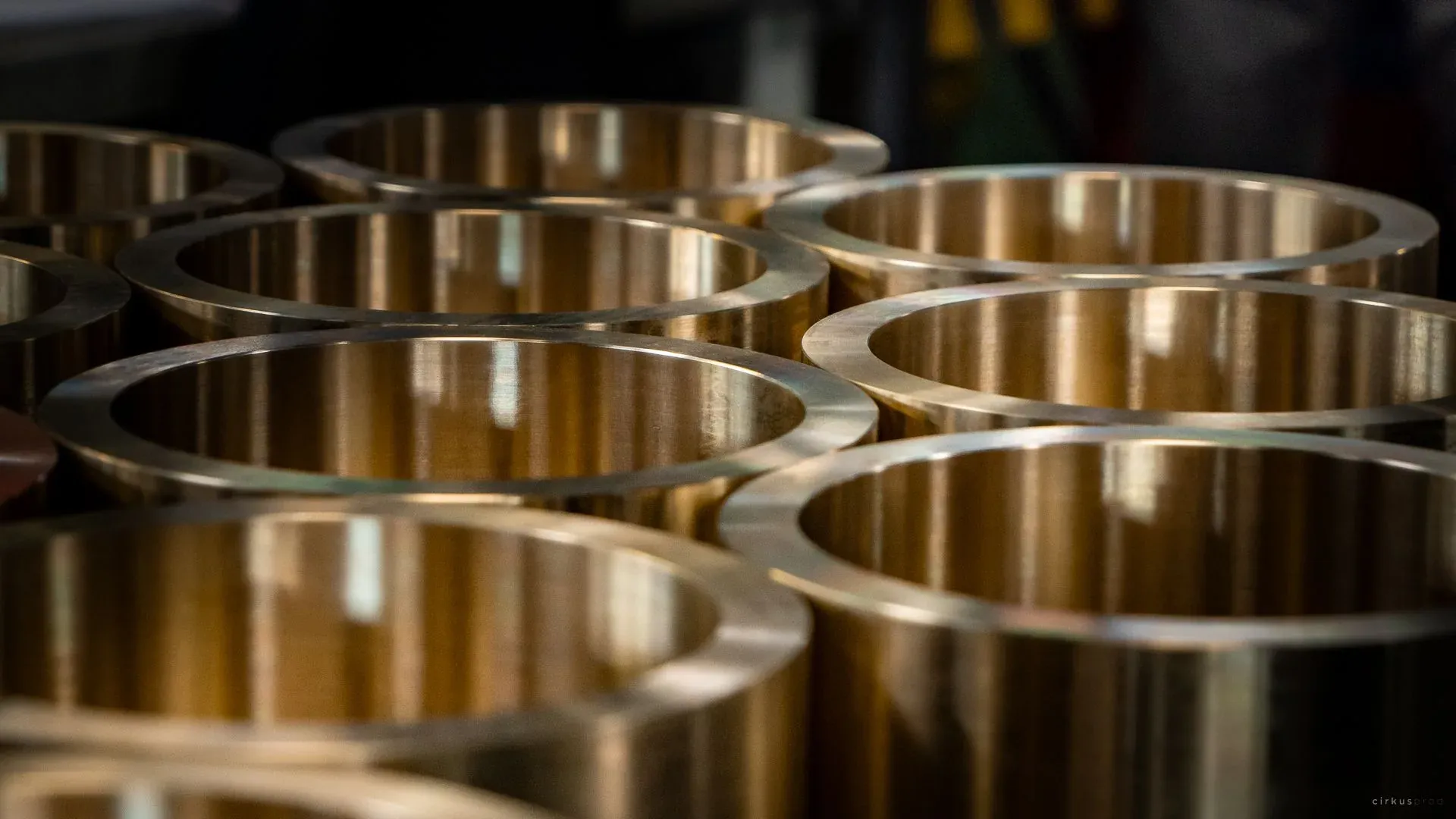 Rows of machined bronze bushings standing on end